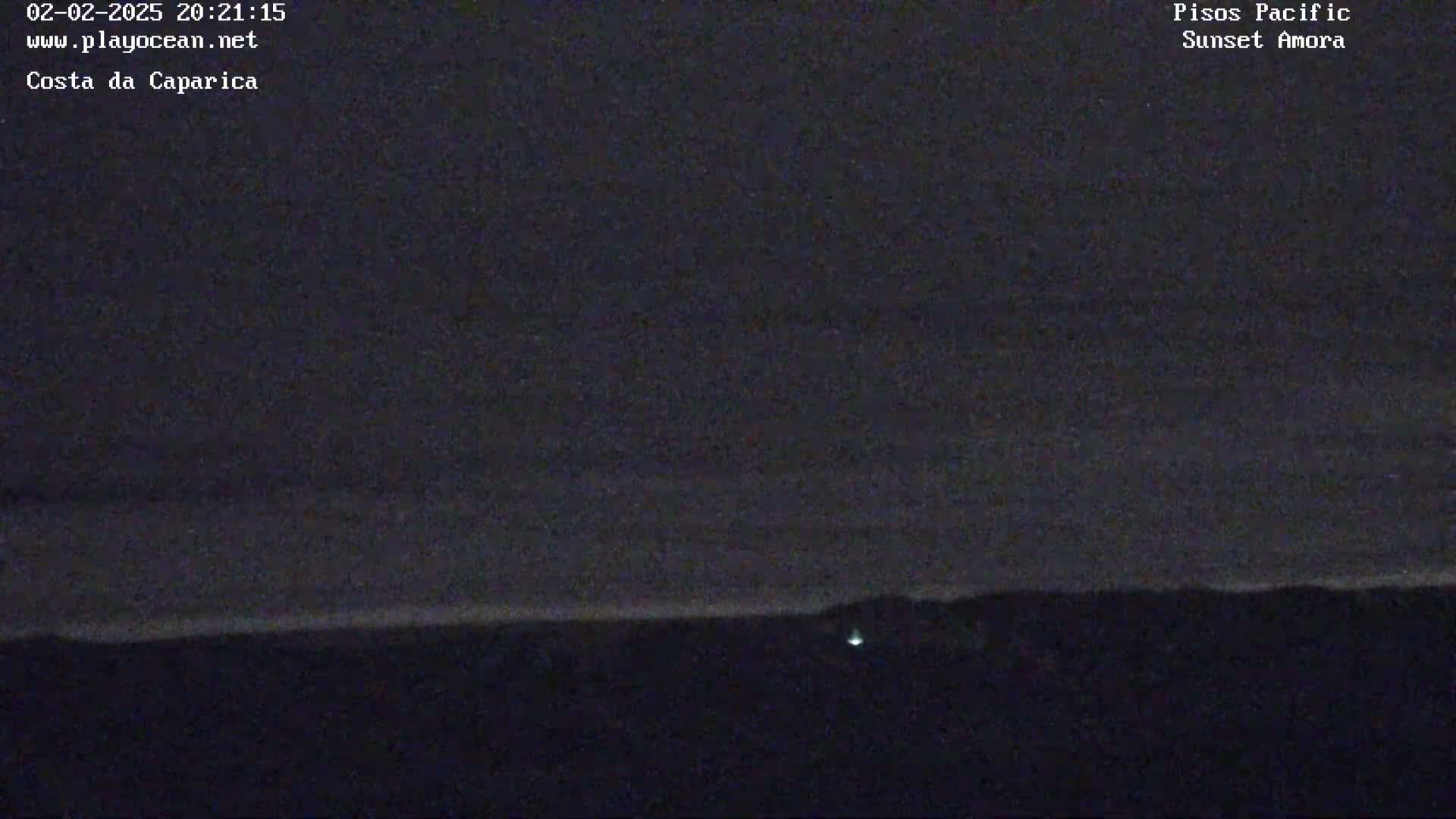 A dark, nighttime landscape shows a horizon line separating a dark sky from a dark landmass, with a single, faint light visible near the bottom.