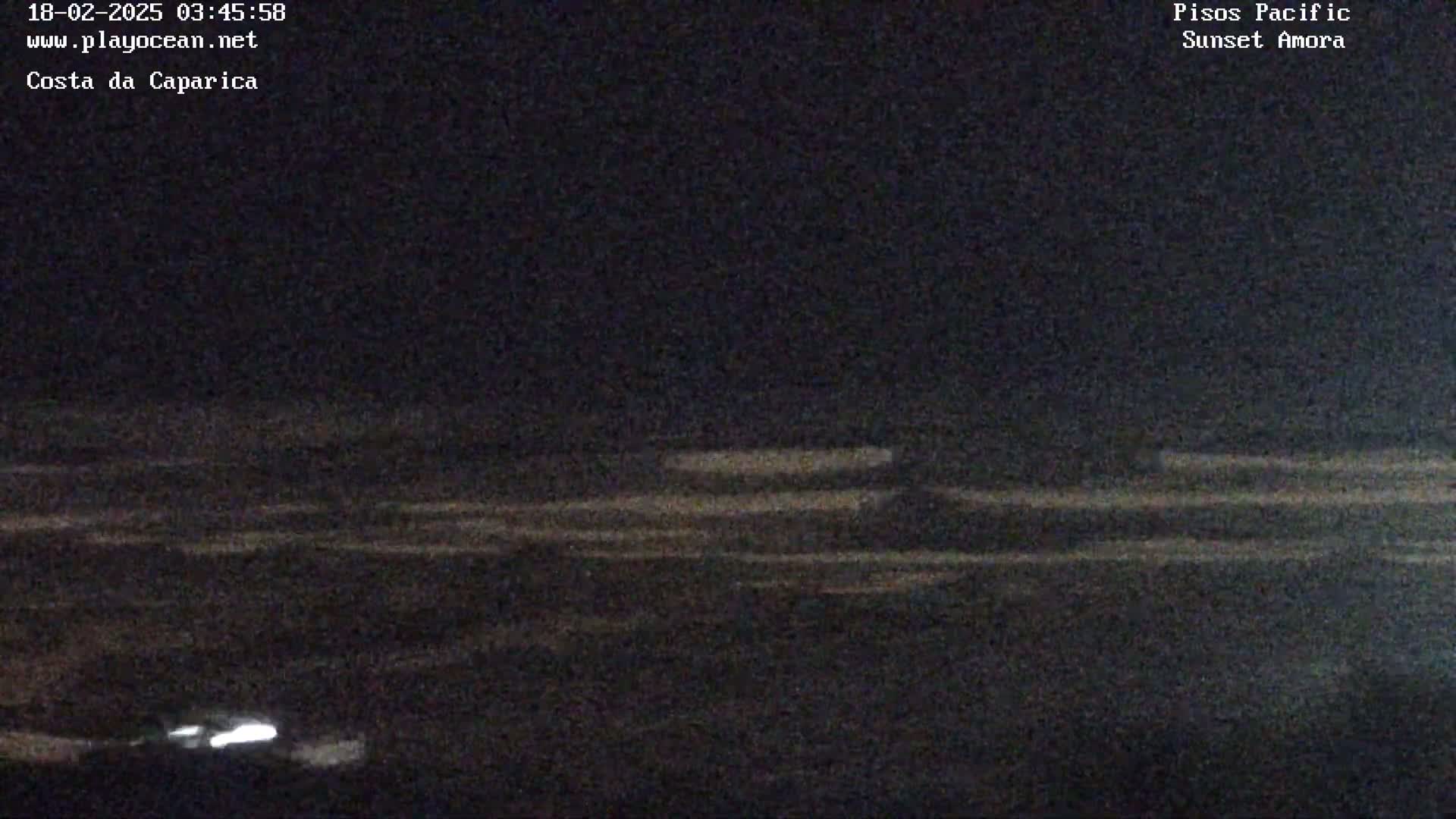 A dark, nighttime view of a flat, seemingly empty landscape under a clear sky.