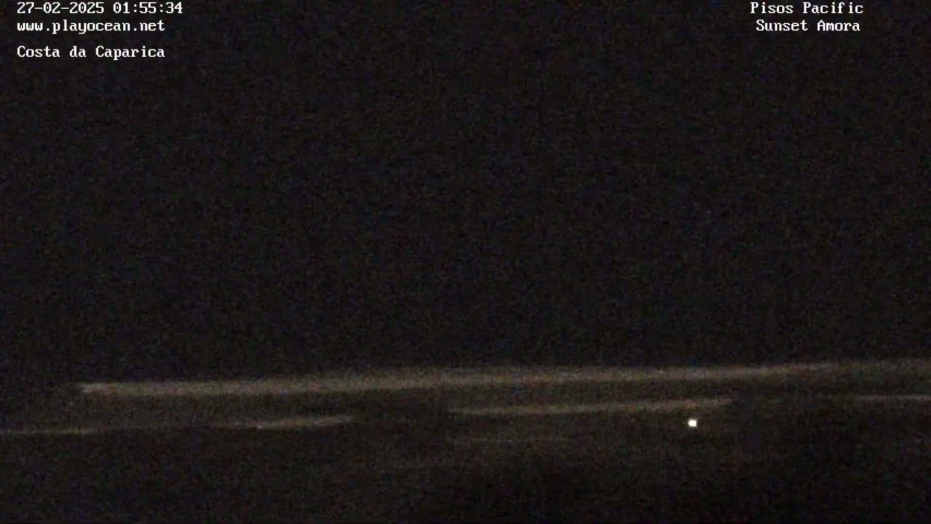 A dark nighttime scene shows a faint, horizontally striped ocean under a clear, dark sky with a single, small light visible near the bottom.