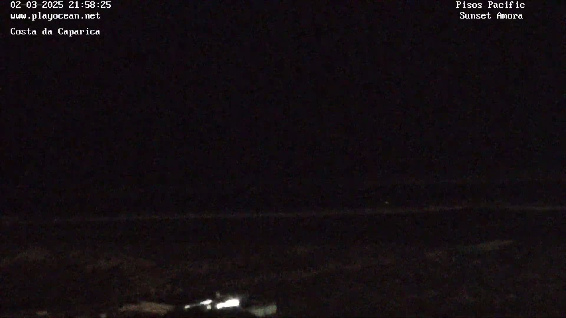 A dark nighttime scene shows a dimly lit ocean horizon.