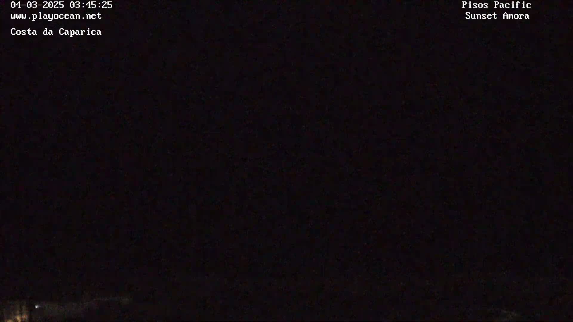 A nighttime, dark image shows a faint, distant horizon line.