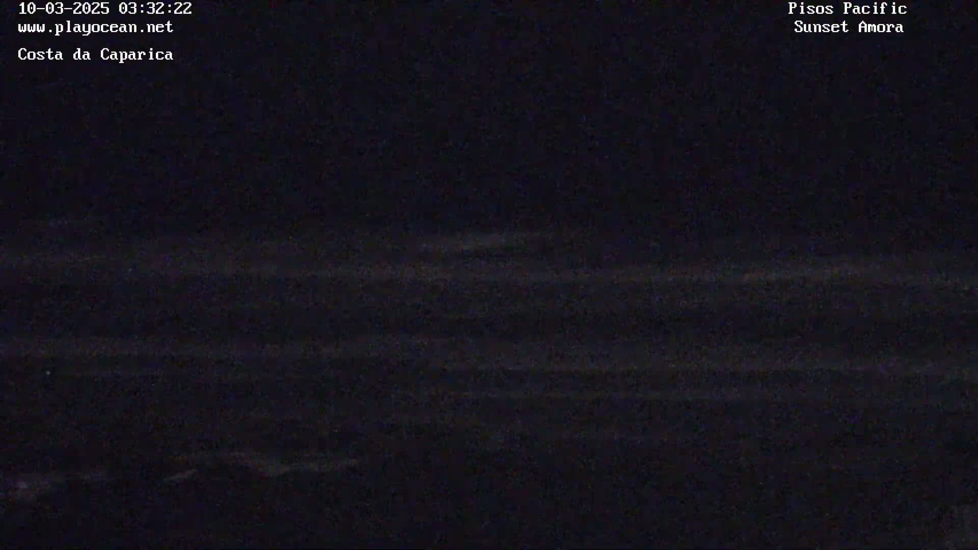 A dark, nighttime view of the ocean with barely visible waves.