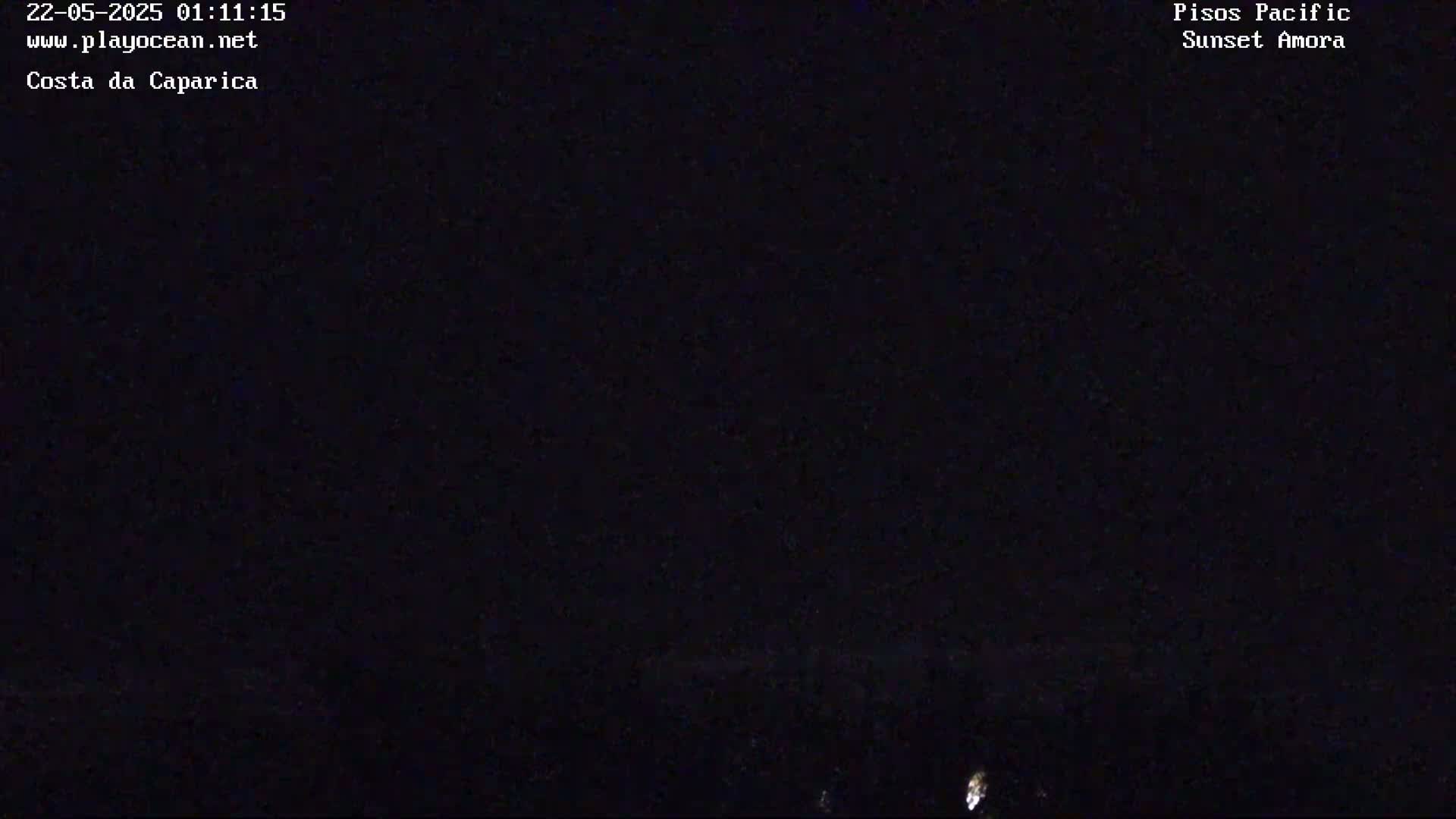 A dark, nighttime scene shows a faint light source near the bottom of the frame.