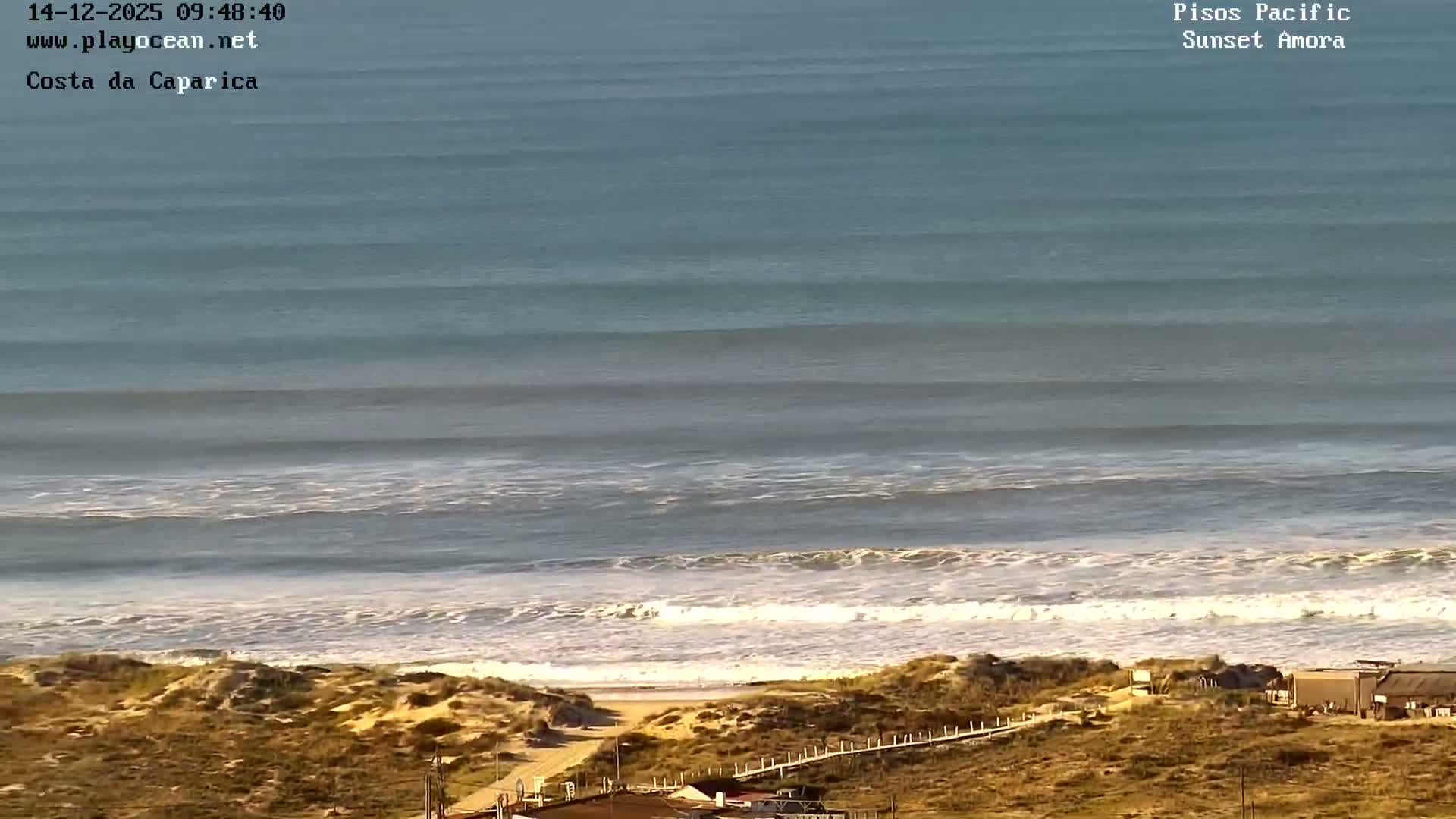 The image displays a nearly pitch-black outdoor scene at night, with only a faint, unidentifiable light source visible at the bottom left, and no discernible weather conditions.