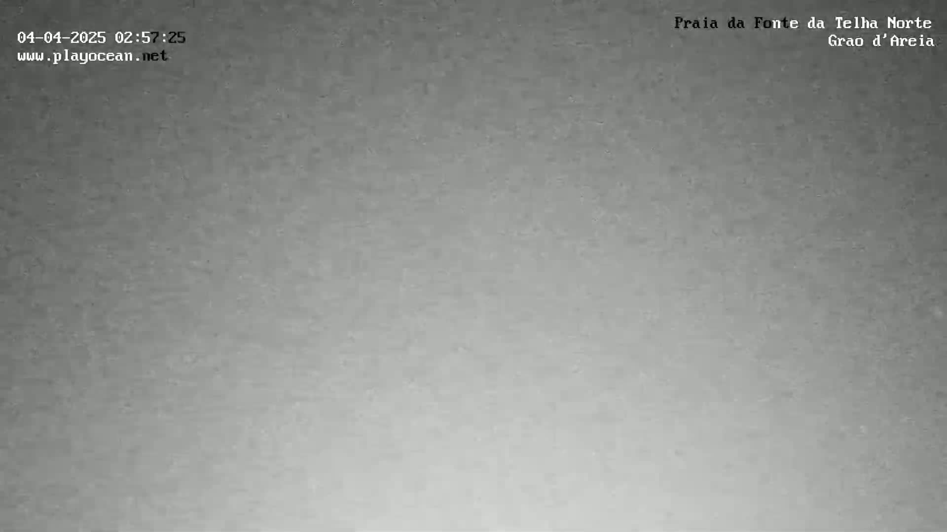 A grainy, mostly gray image shows an overcast sky.
