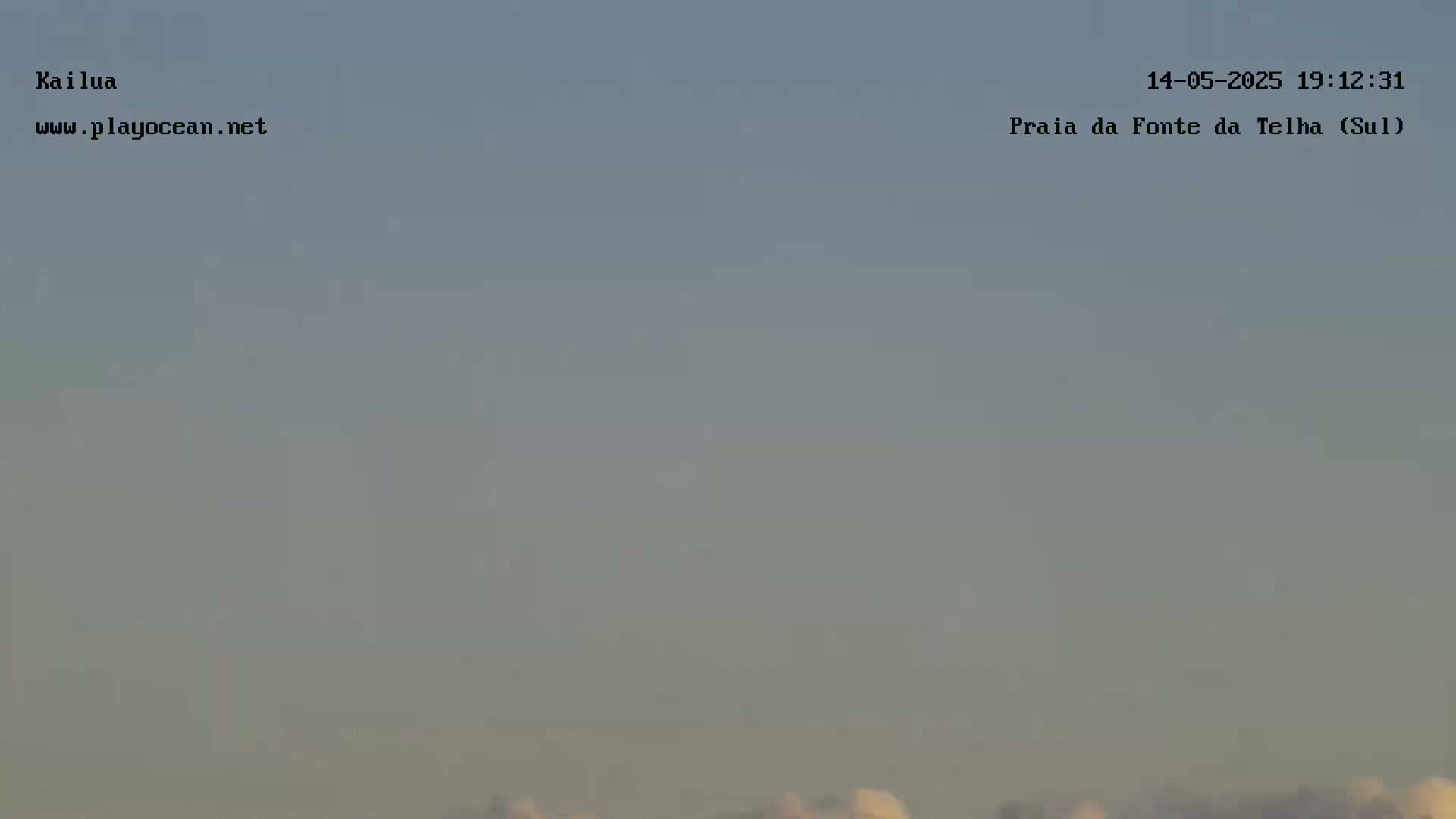 A hazy, overcast sky shows a hint of light on the horizon.