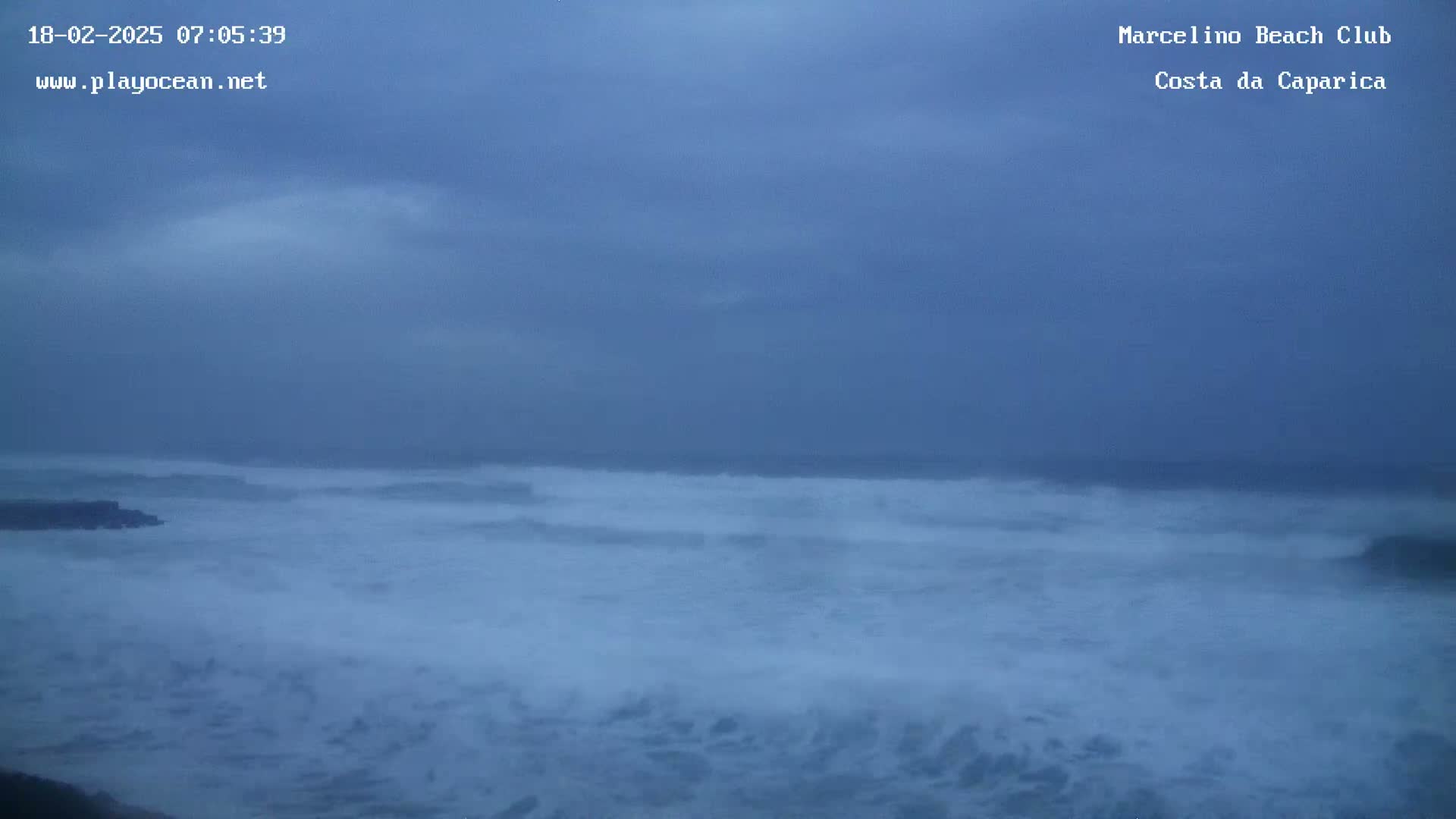 A wide shot shows a stormy ocean under an overcast sky.