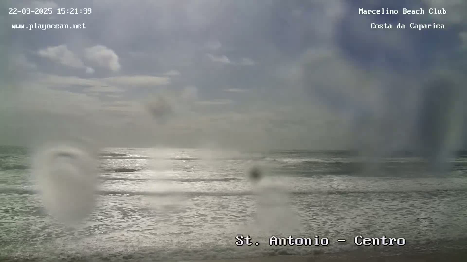 A somewhat overcast sky hangs over a wavy ocean with whitecaps under cloudy conditions.
