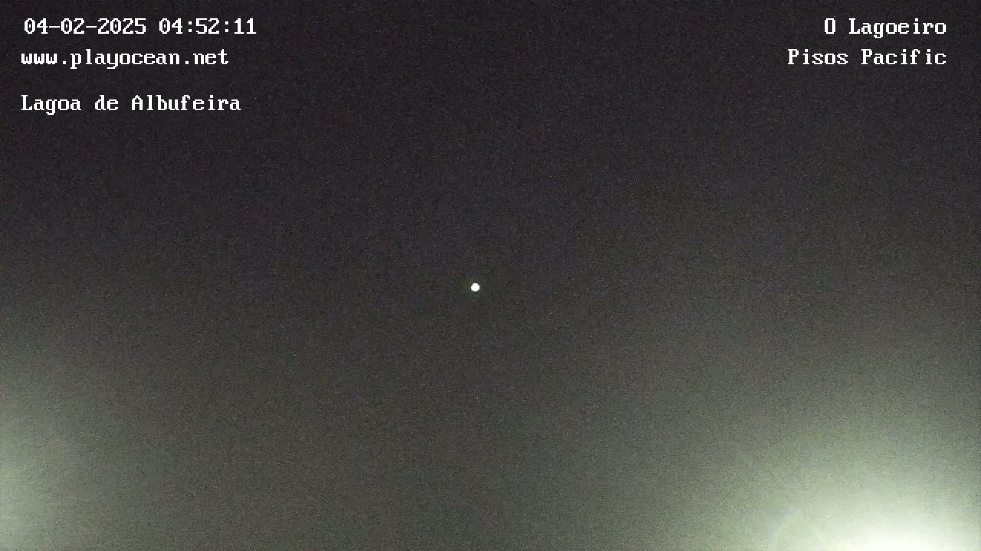 A bright light is visible in the dark night sky.