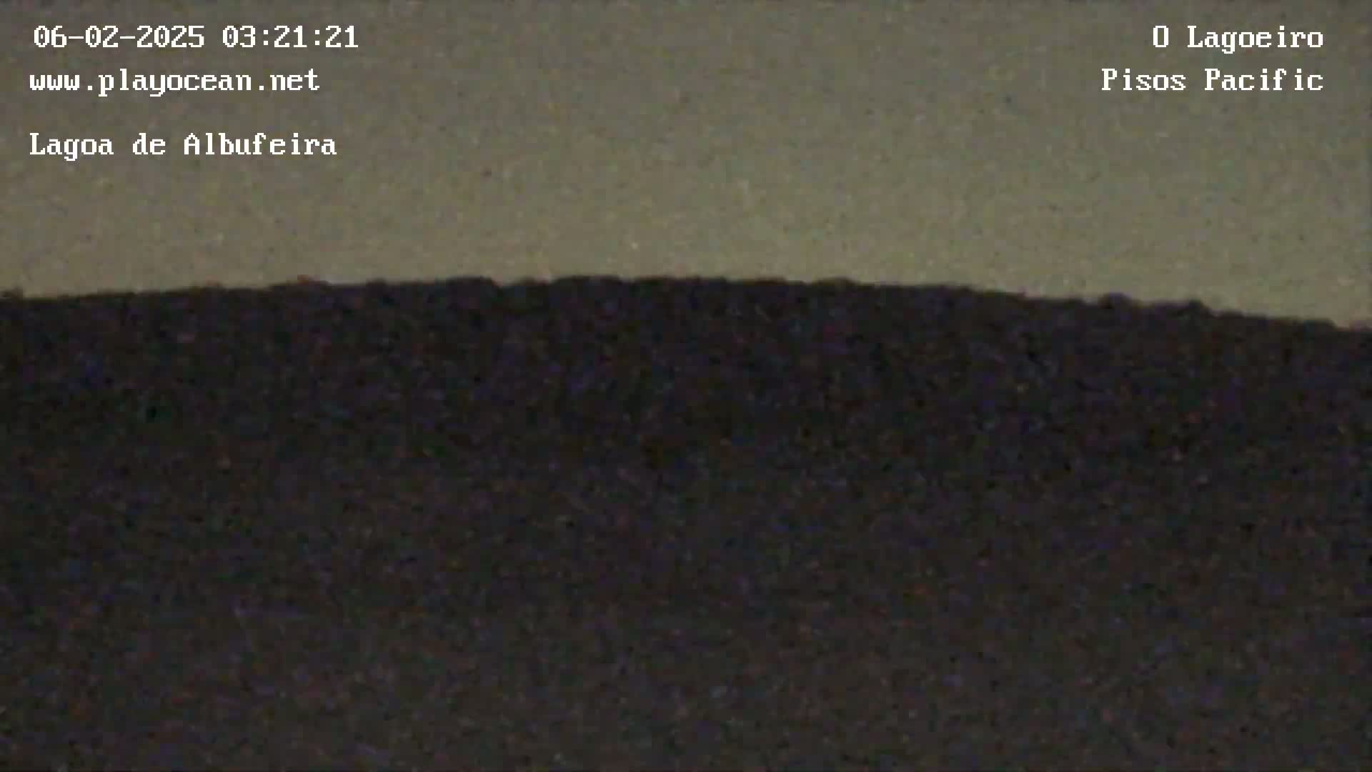 A dark, low-lying landmass is visible under a light gray sky.