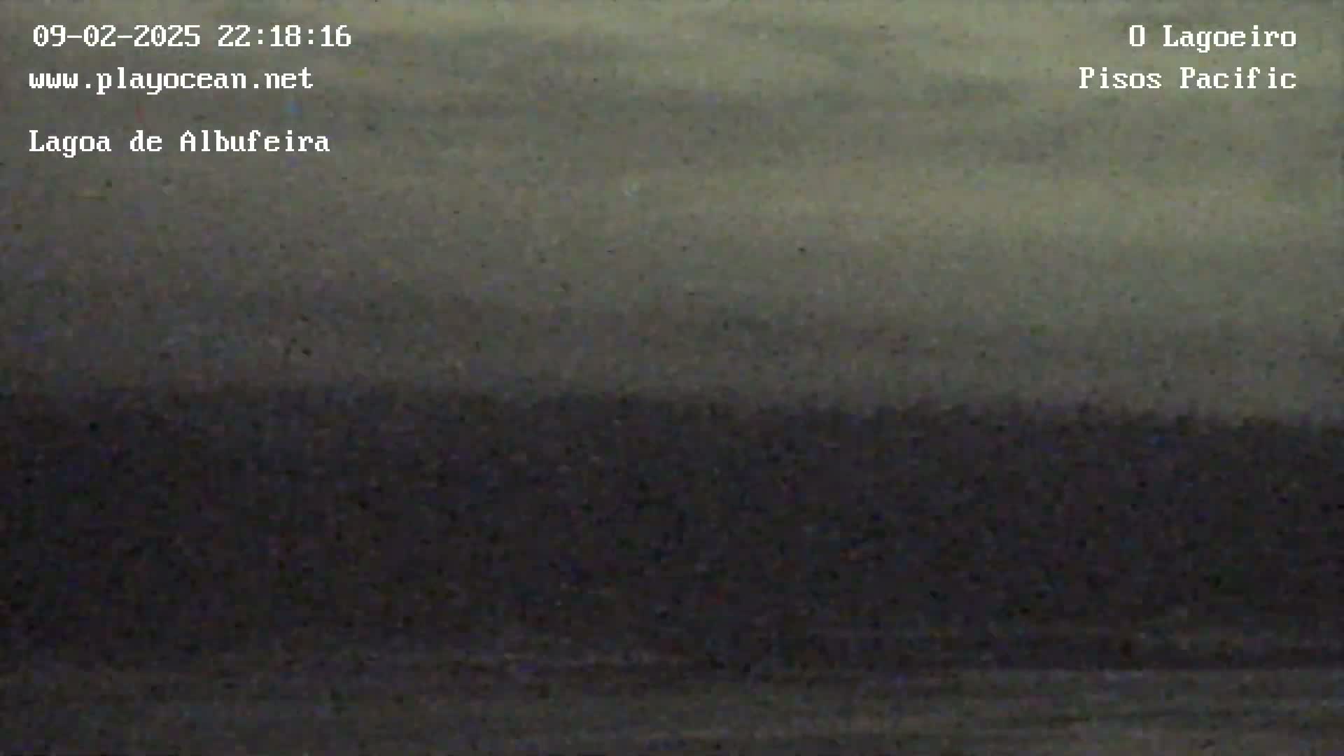 A dark, overcast sky hangs over a flat, dark landscape.