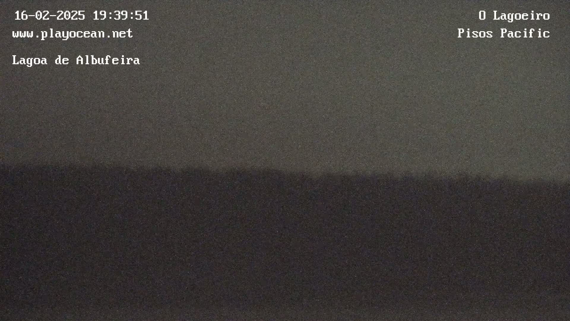 A dark, blurry image shows a low-light horizon line separating a slightly lighter sky from a darker ground, suggesting nighttime conditions.