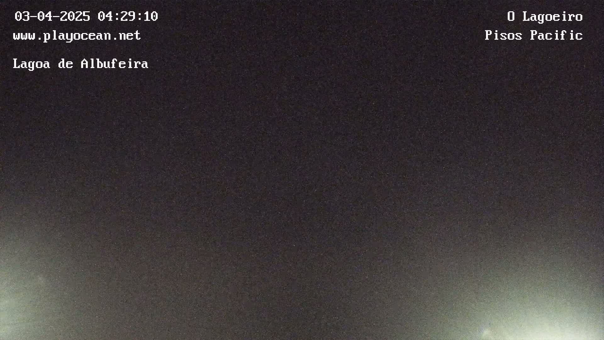 A dark, nighttime scene shows a mostly clear sky with a faint, light glow near the bottom.