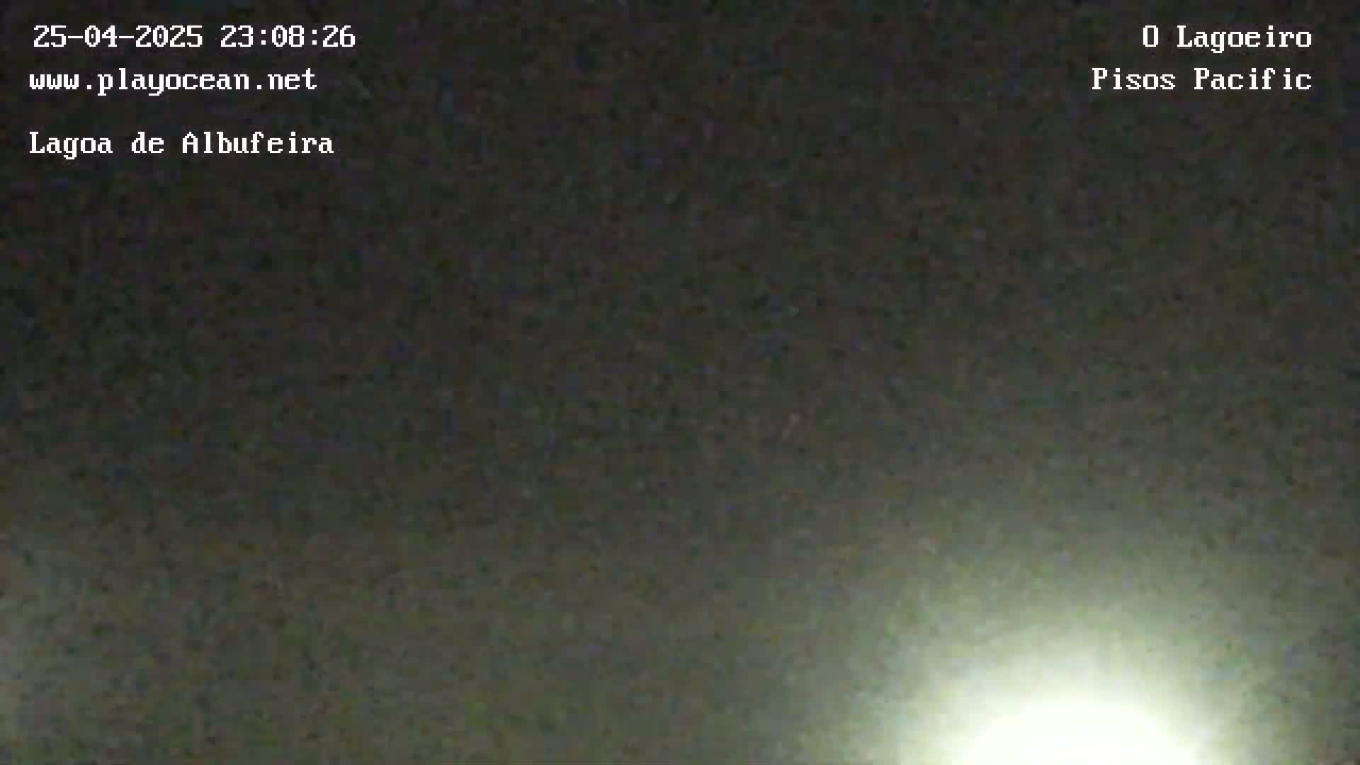 A bright light shines from the bottom of a dark, nighttime scene.