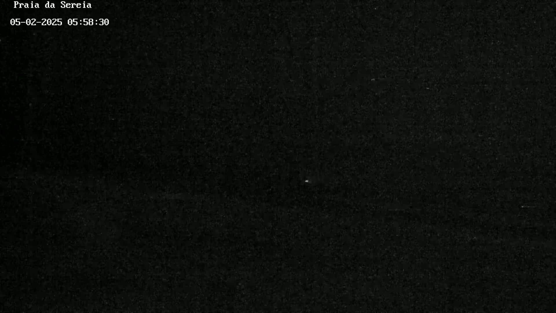 A dark, grainy image shows a mostly black sky at night.