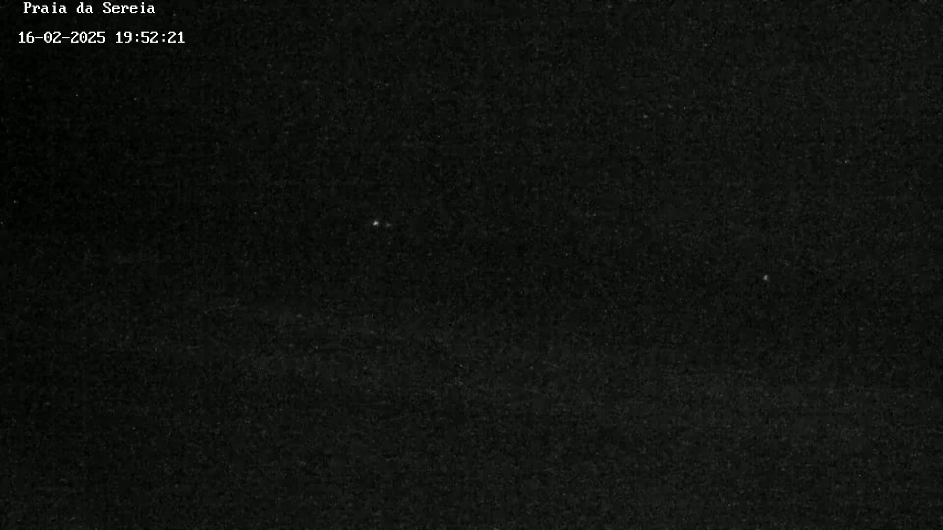 A nighttime image shows a dark sky speckled with faint stars.