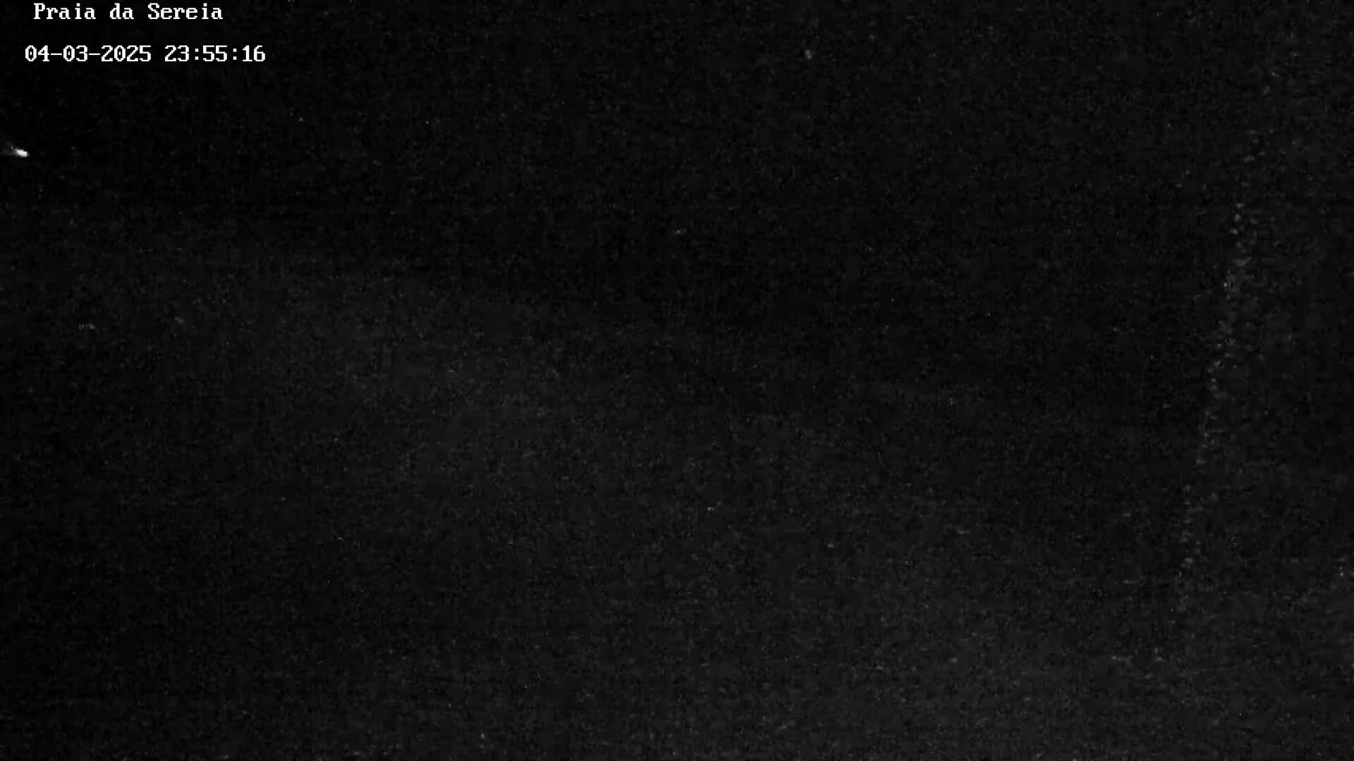 A mostly black image shows a night sky with a few very faint specks of light.