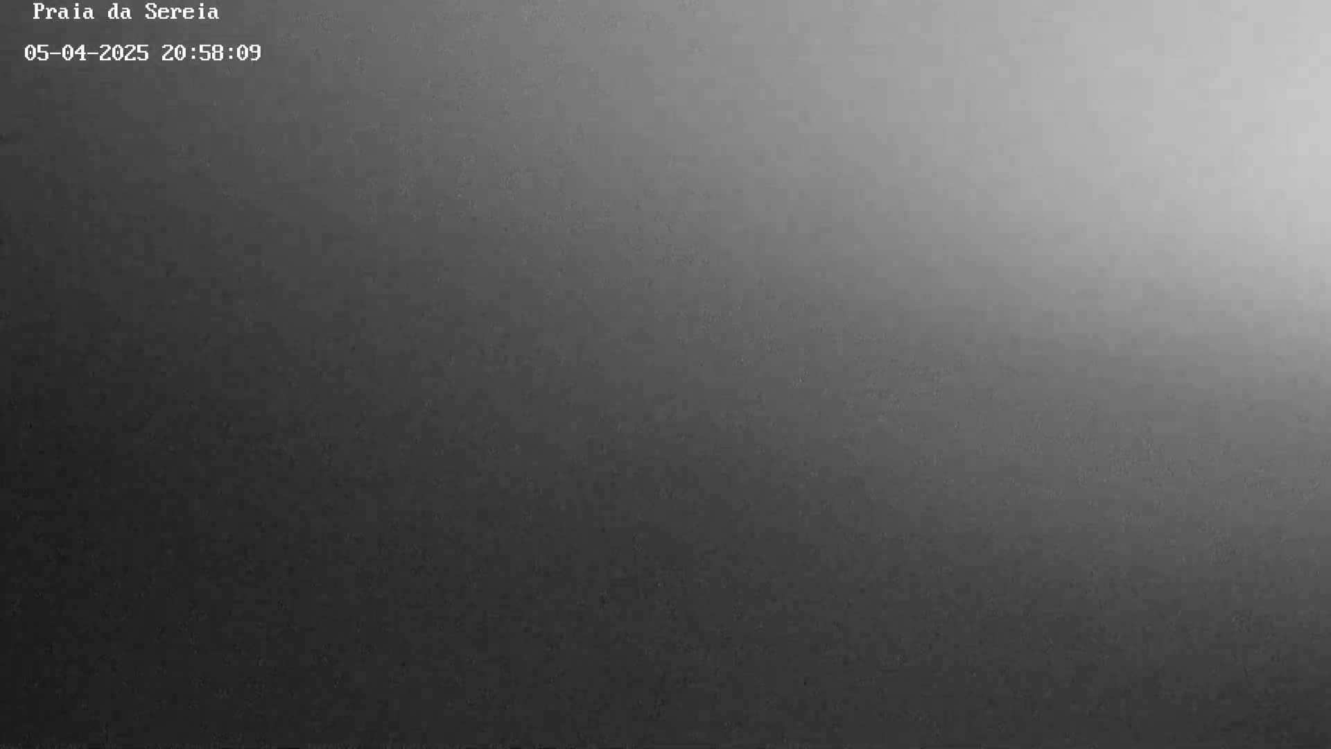 A dark gray, grainy image gradually brightens to a lighter gray at the top.