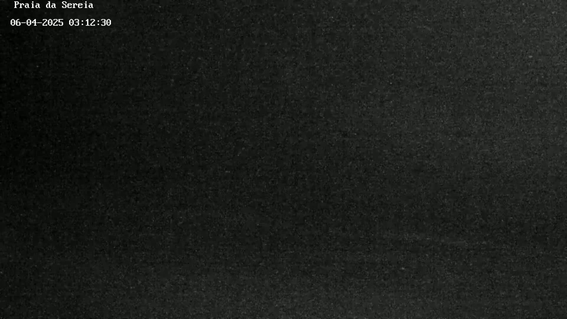 A dark, grainy image shows a solid black surface.