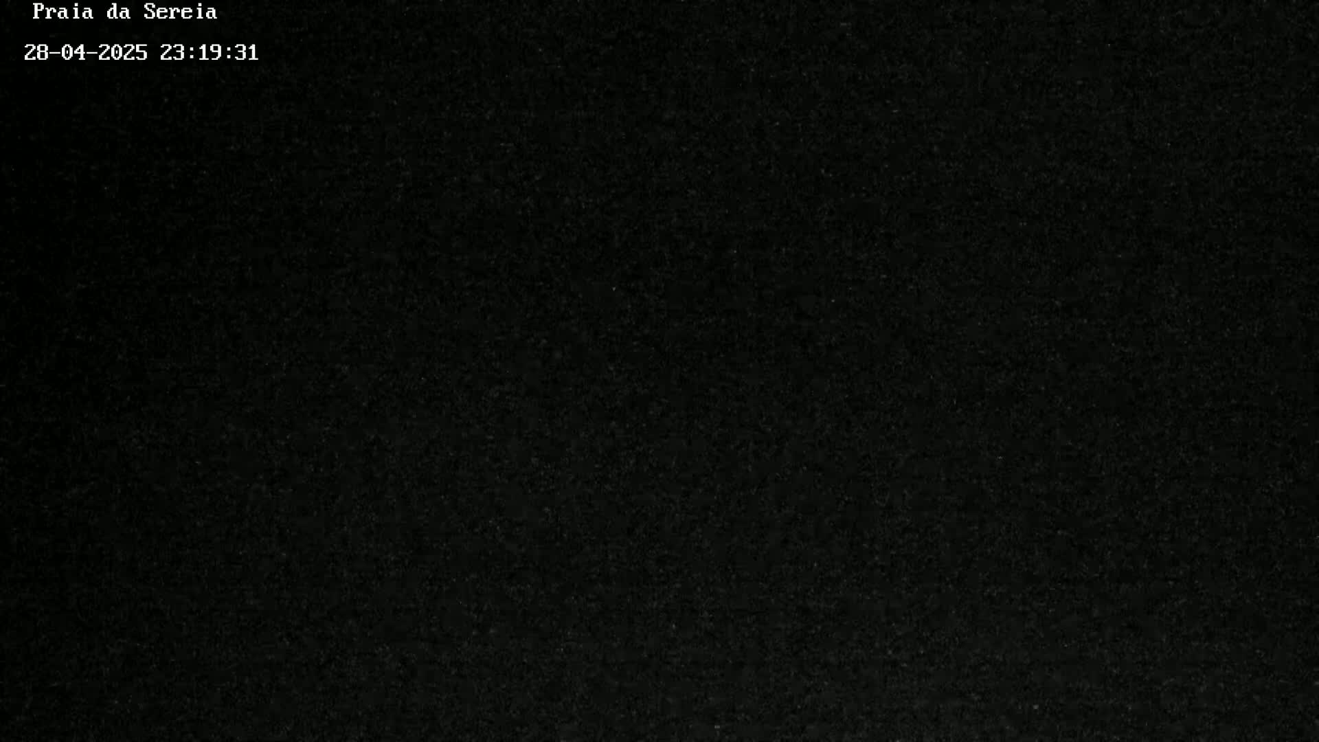 The image is a completely dark, grainy, black screen.