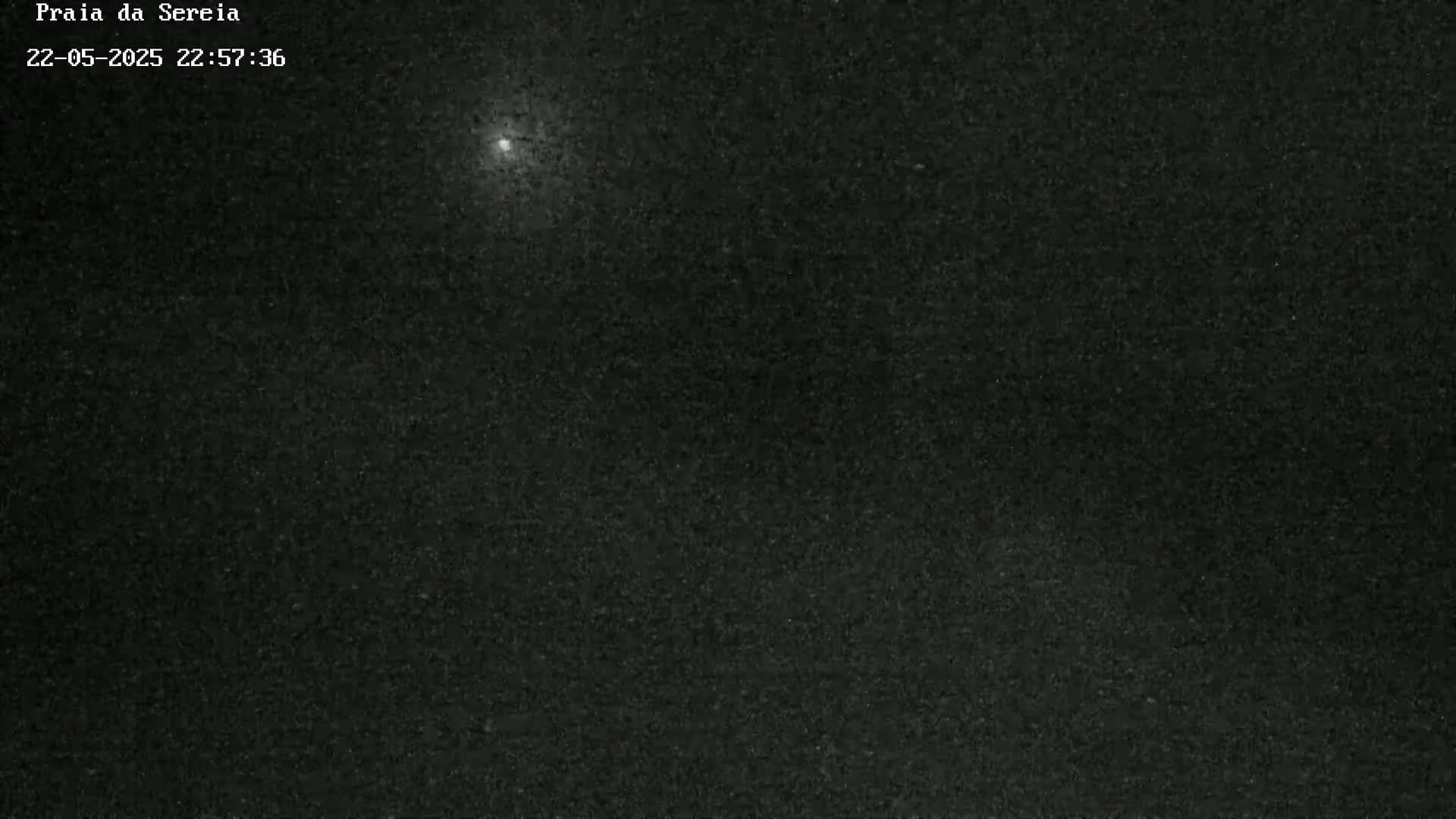 A bright object is visible in a dark, nighttime sky.