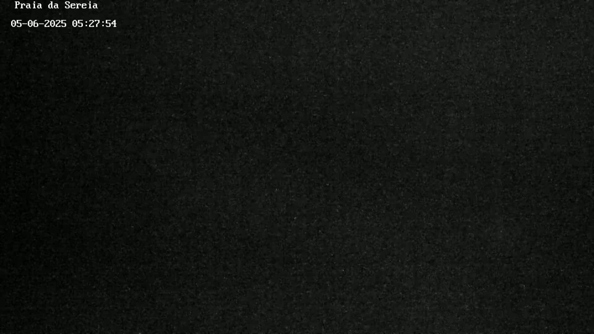 The image shows a completely dark, grainy surface.