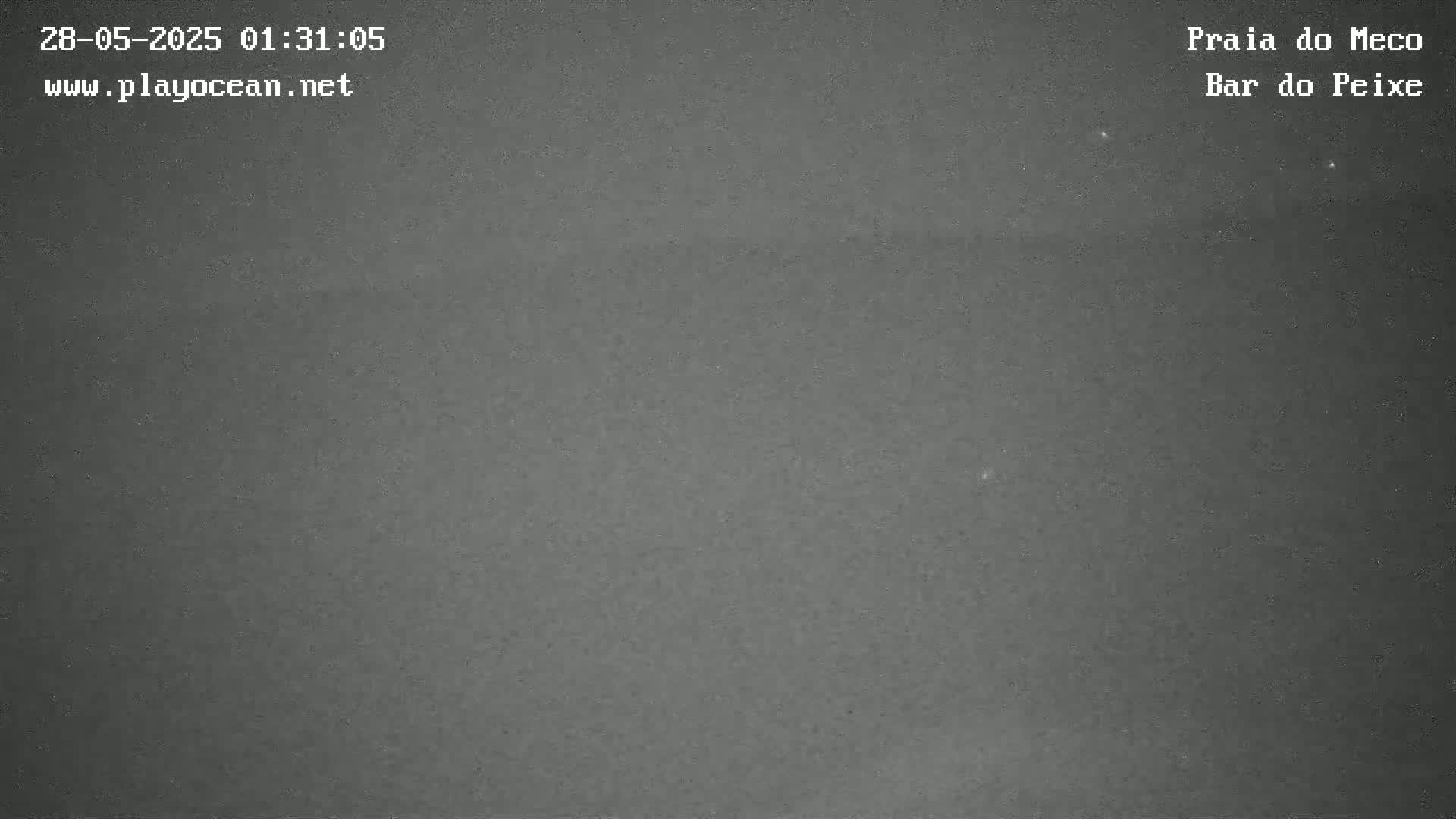 A dark, nighttime image of a mostly clear sky shows a few faint, distant lights.