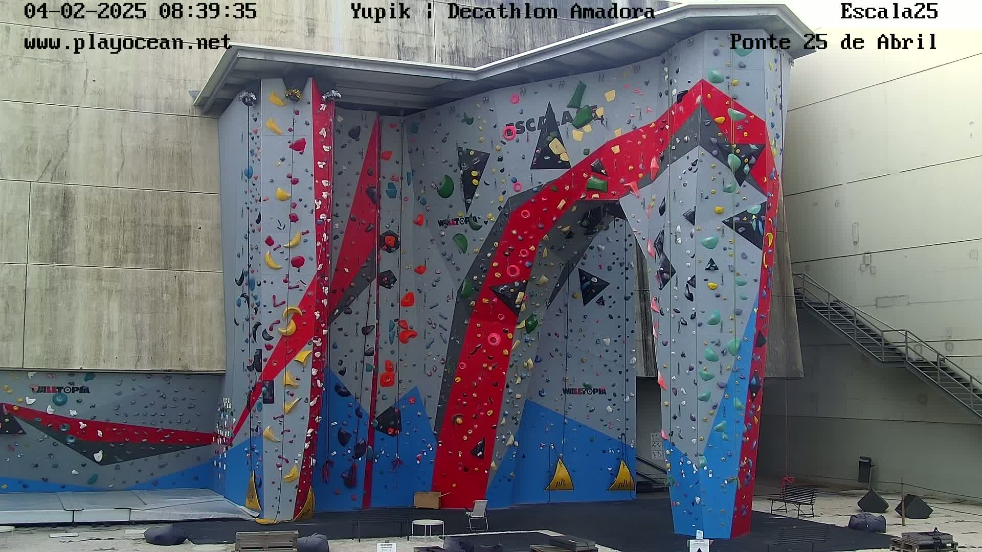 A large, colorful indoor climbing wall with various holds and routes.