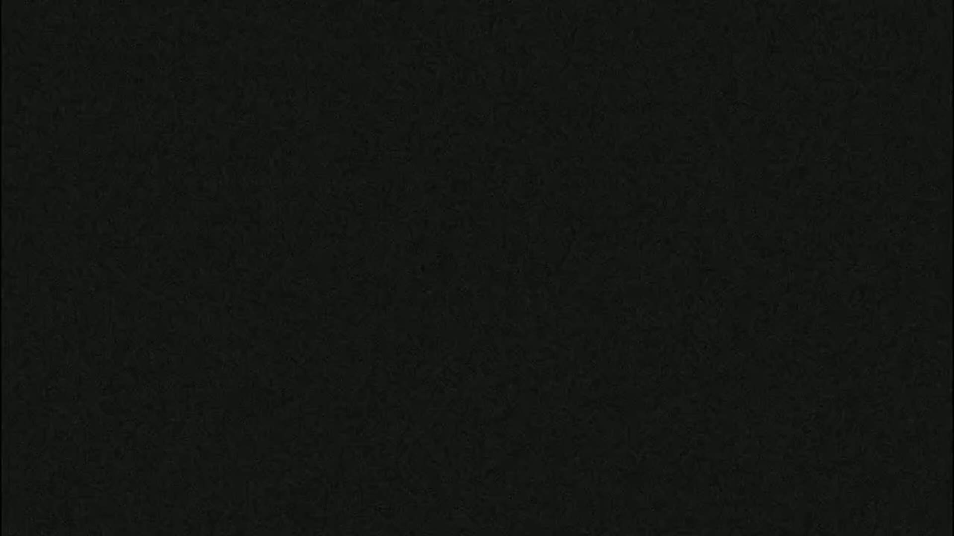 The image shows a dark gray textured surface.