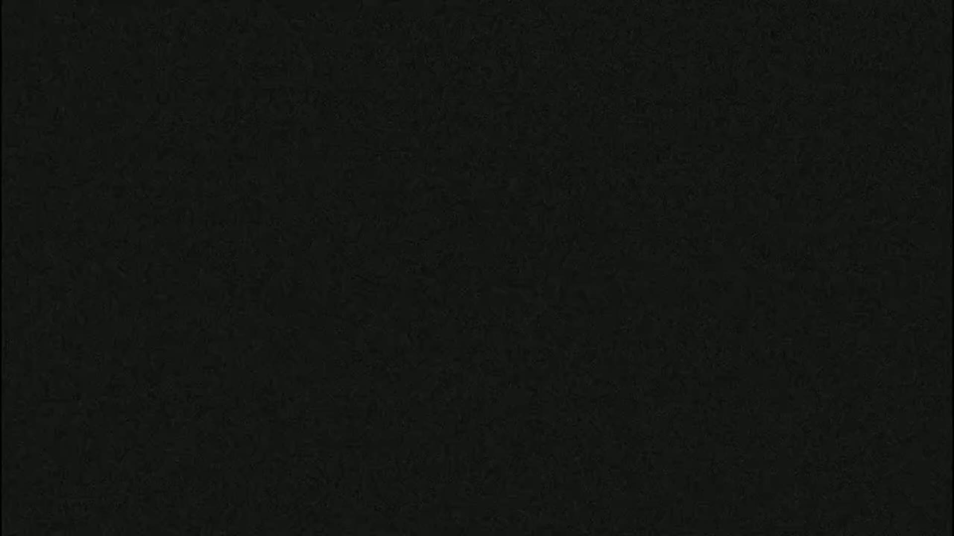 The image is a solid dark-grey-black textured background.