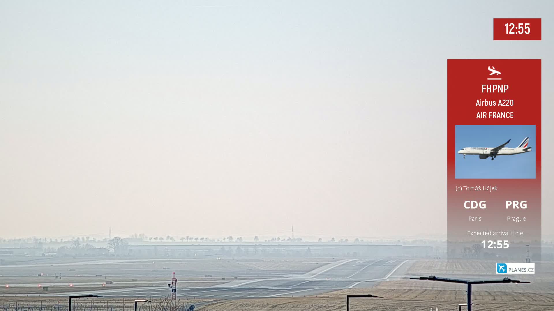 A hazy view of an airport runway with a plane in the distance.