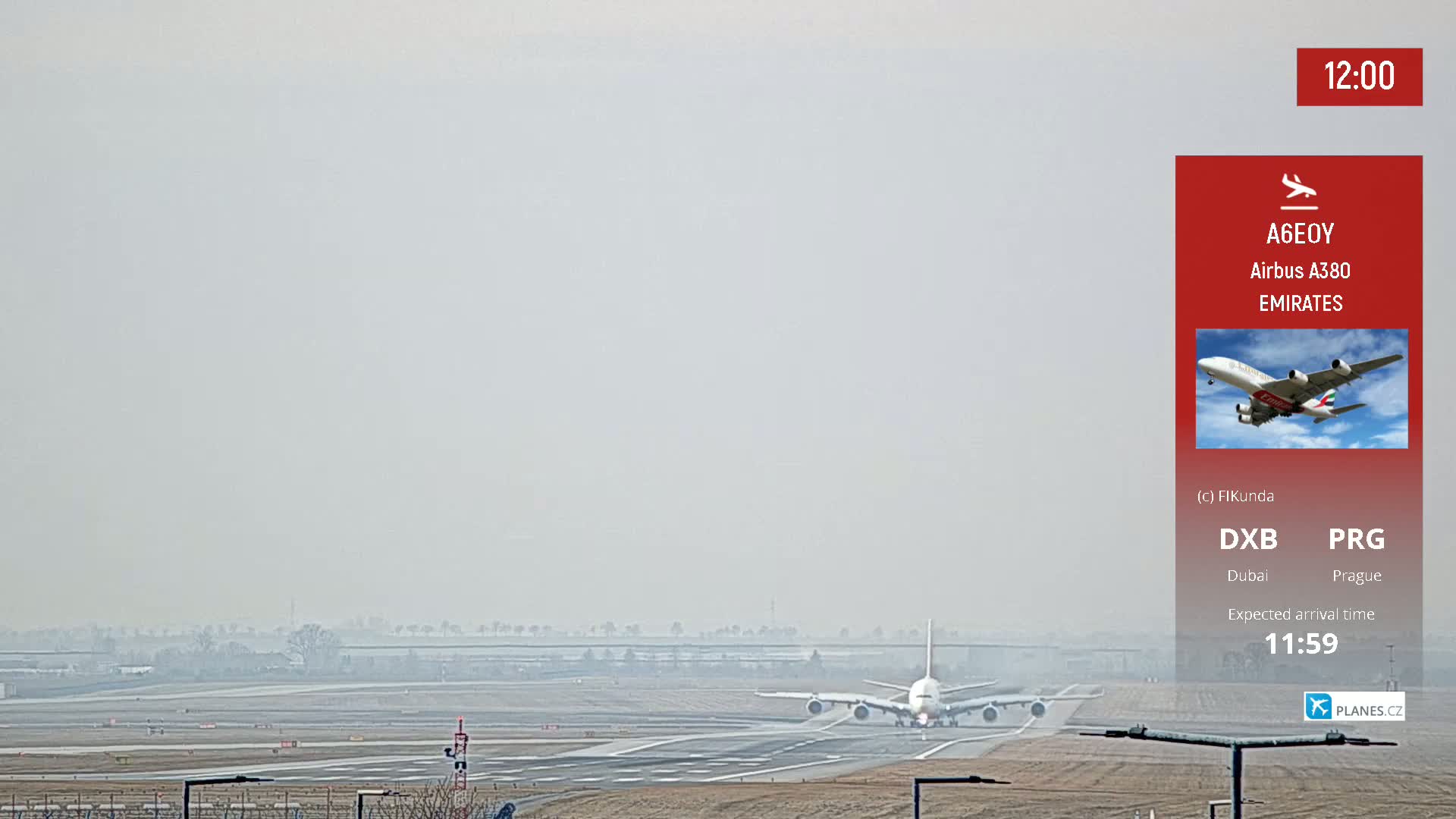 A large passenger plane lands on a runway on a hazy day.