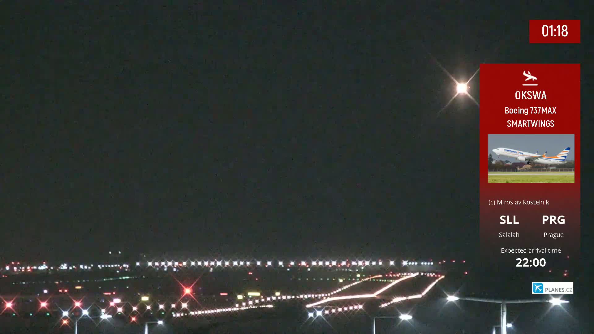 A nighttime airport runway scene showing lights illuminating the tarmac under a clear, dark sky.