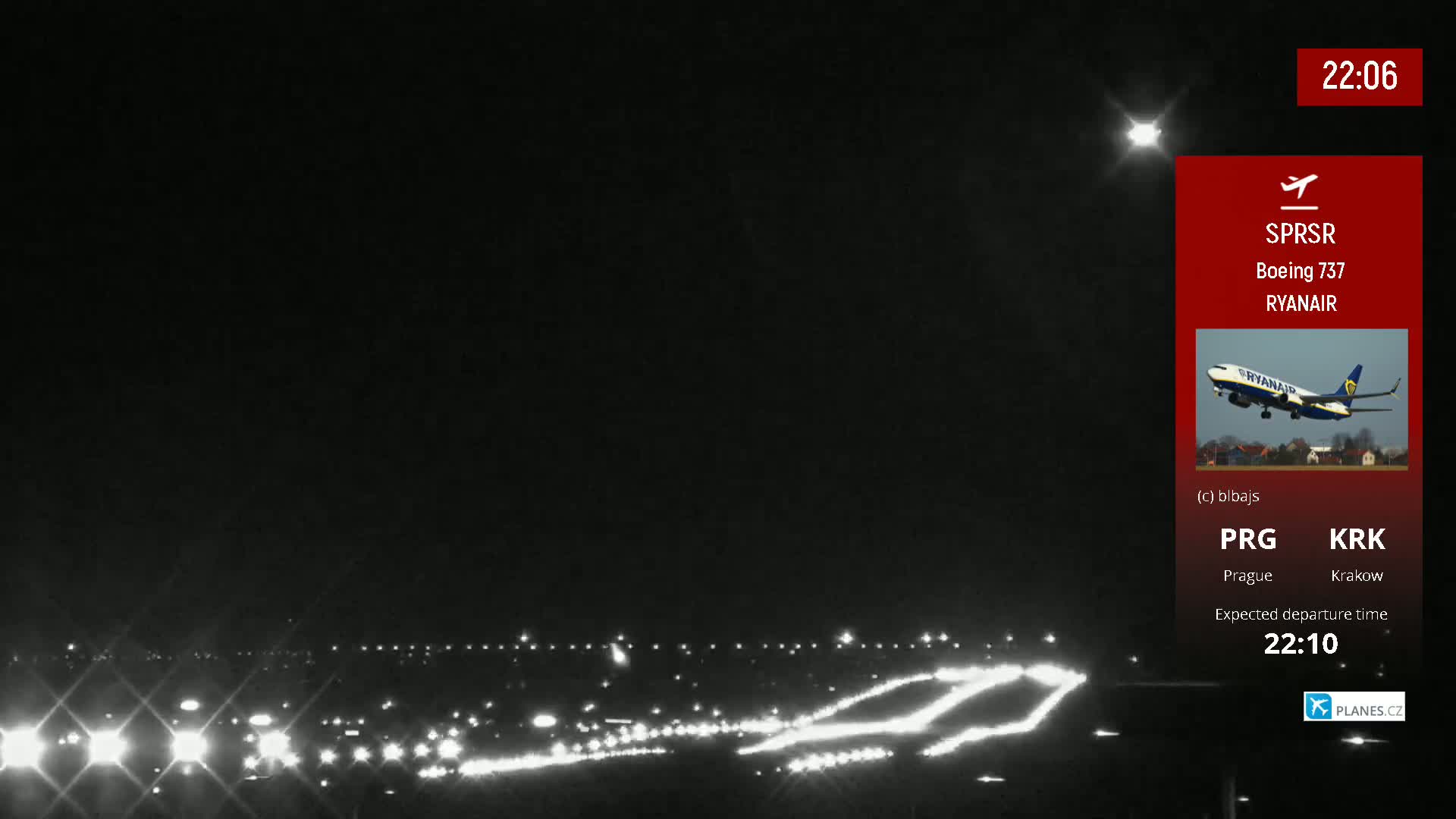 A nighttime airport runway with lights illuminating the tarmac under a clear, dark sky.