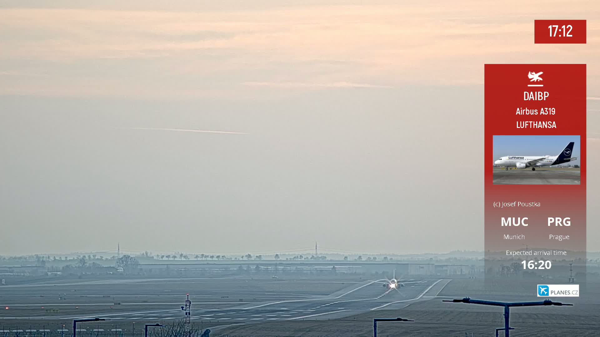 A Lufthansa Airbus A319 airplane is taxiing on a runway at an airport on a hazy day.