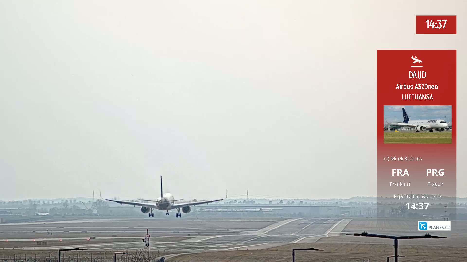 A Lufthansa Airbus A320neo airplane is landing on a runway under hazy conditions.