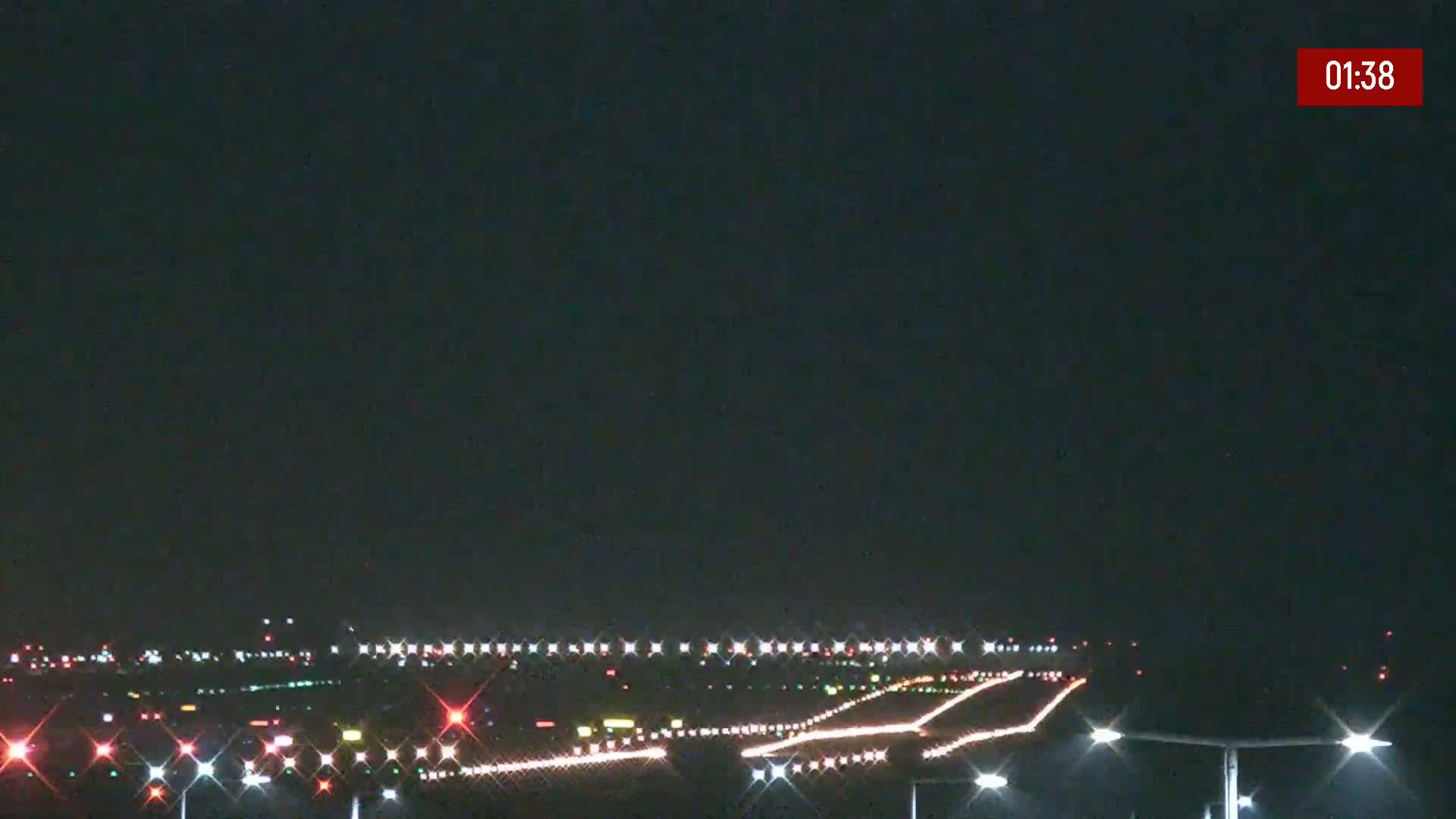 At night, runway lights illuminate a dark airport.