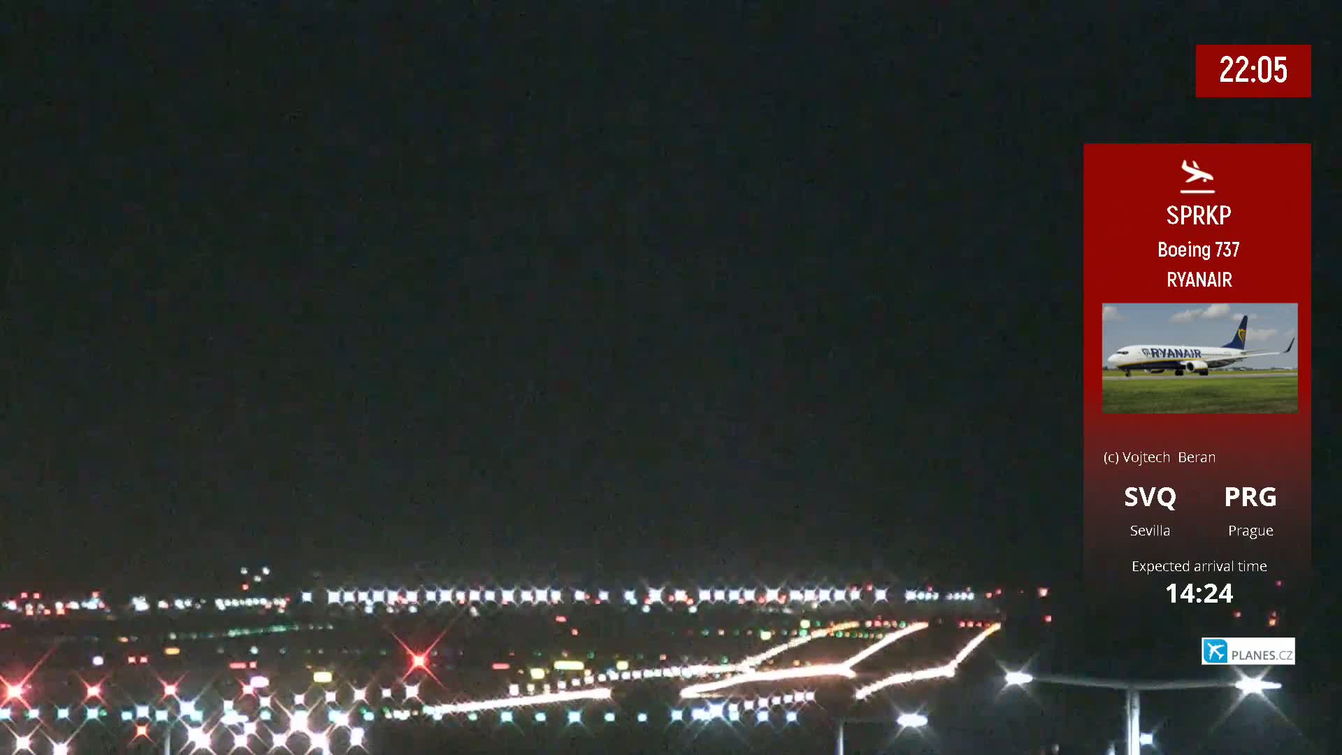 A nighttime view of an airport runway with lights illuminating the tarmac under a dark sky.