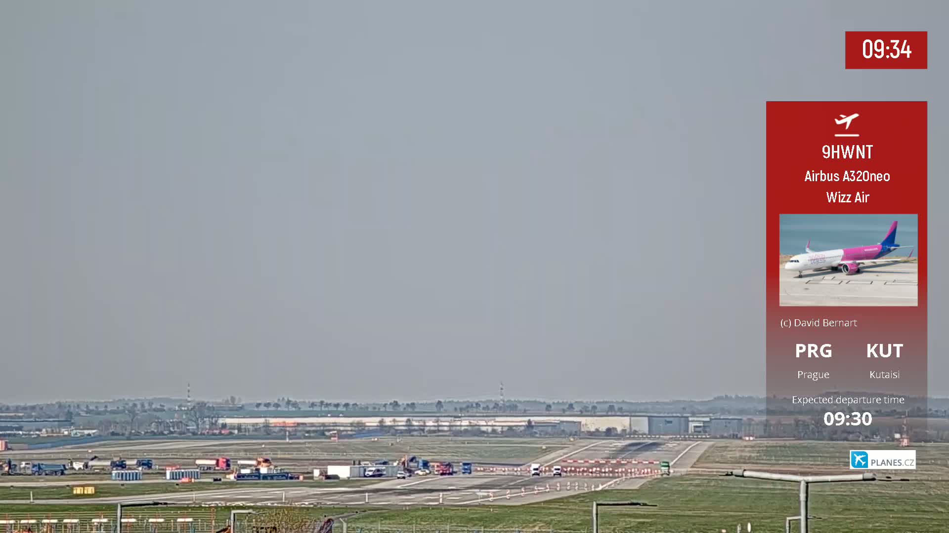 A Wizz Air Airbus A320neo is seen on an airport runway on a hazy day.