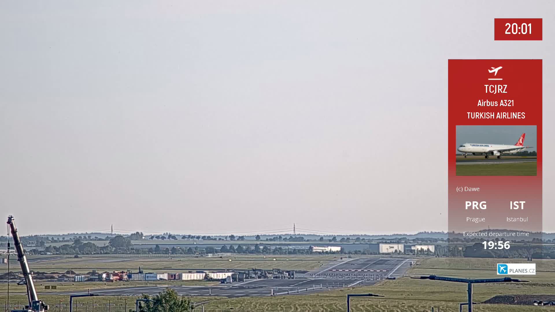 A Turkish Airlines Airbus A321 airplane sits on a runway at an airport under a hazy sky.