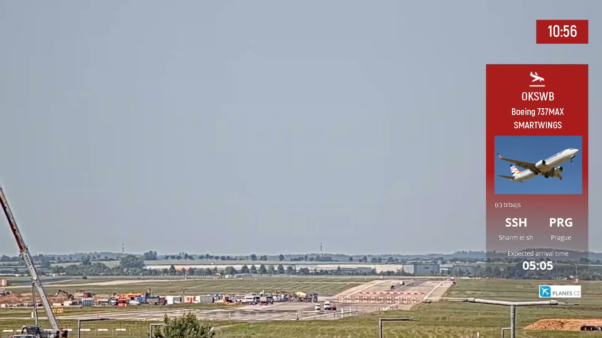 A Boeing 737MAX airplane takes off from an airport runway on a clear, sunny day.