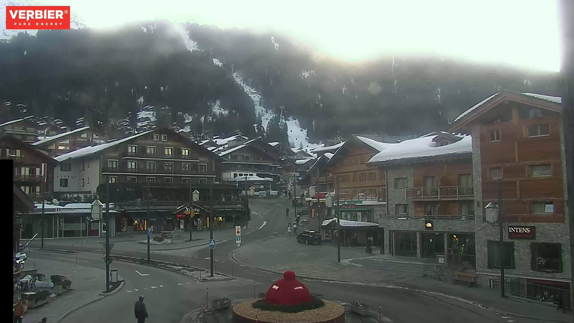 A snow-covered village nestled in a misty mountain valley.