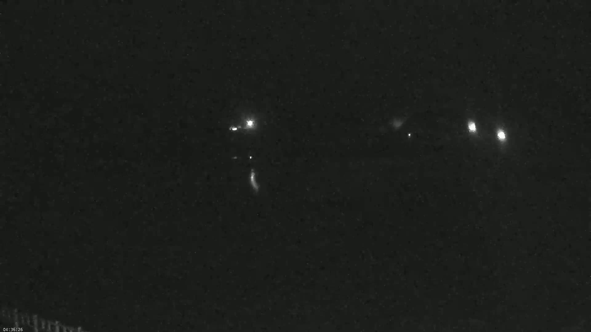 Several bright lights are visible in the nighttime sky.