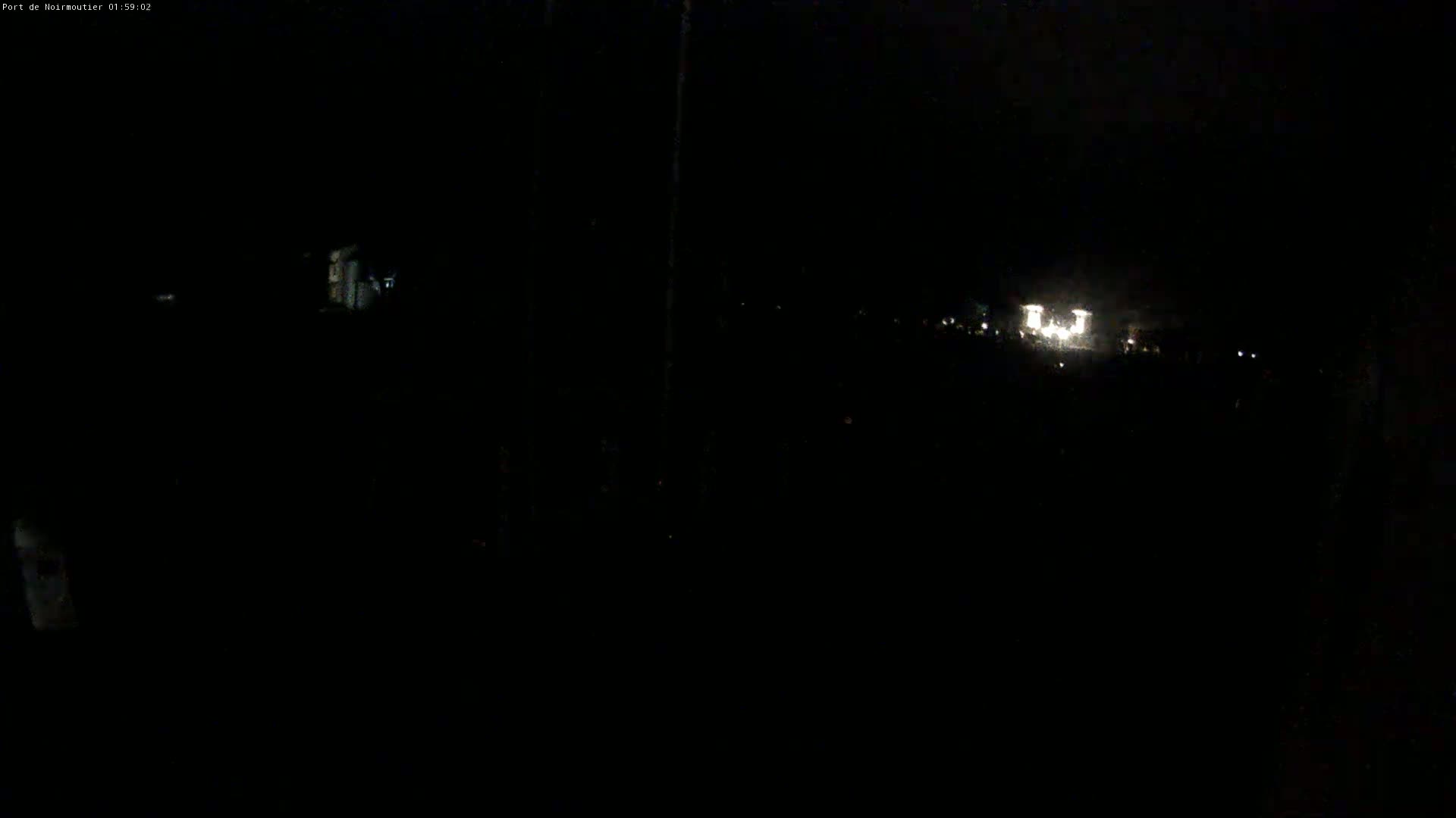 At night, distant lights are visible in the darkness.