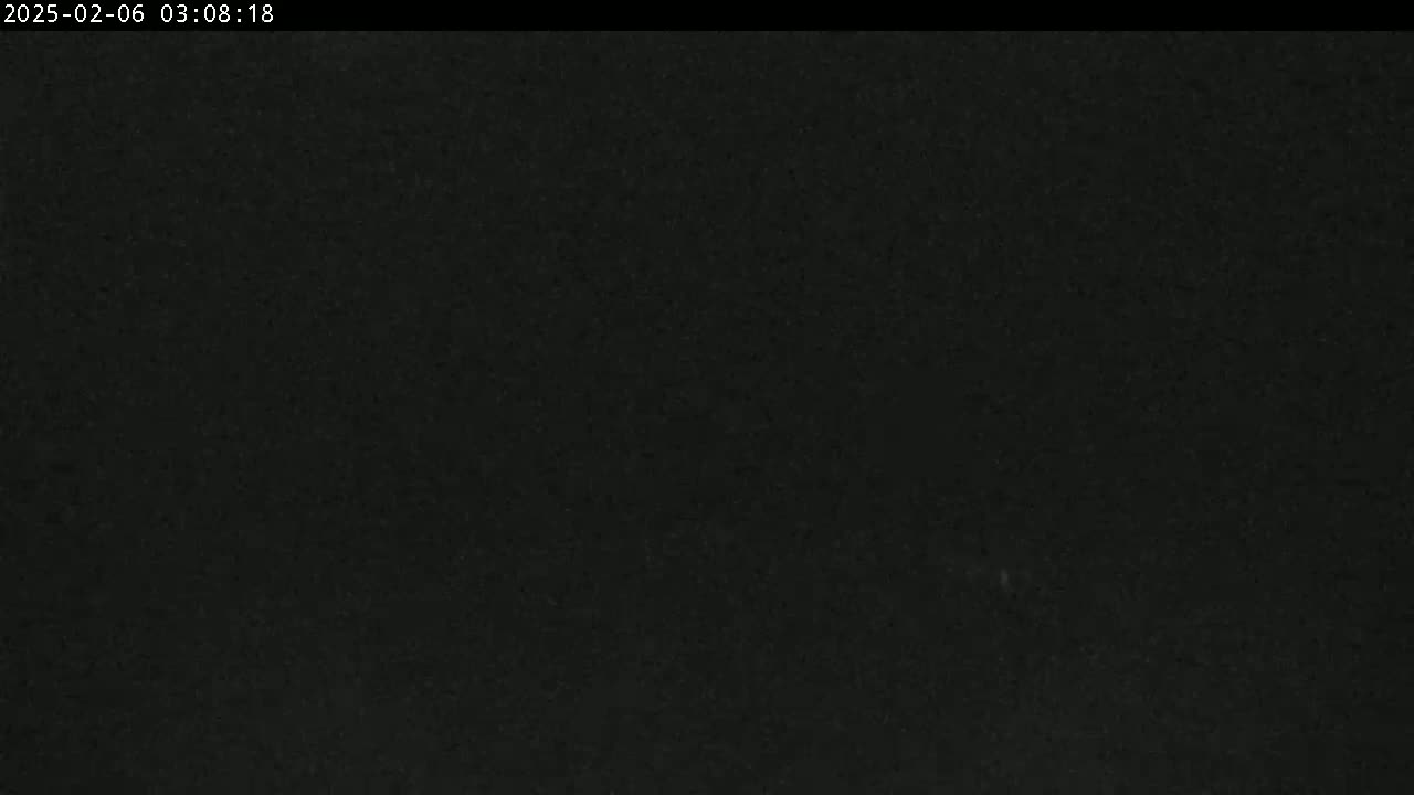 A very dark image shows a solid black surface with minimal texture or detail.
