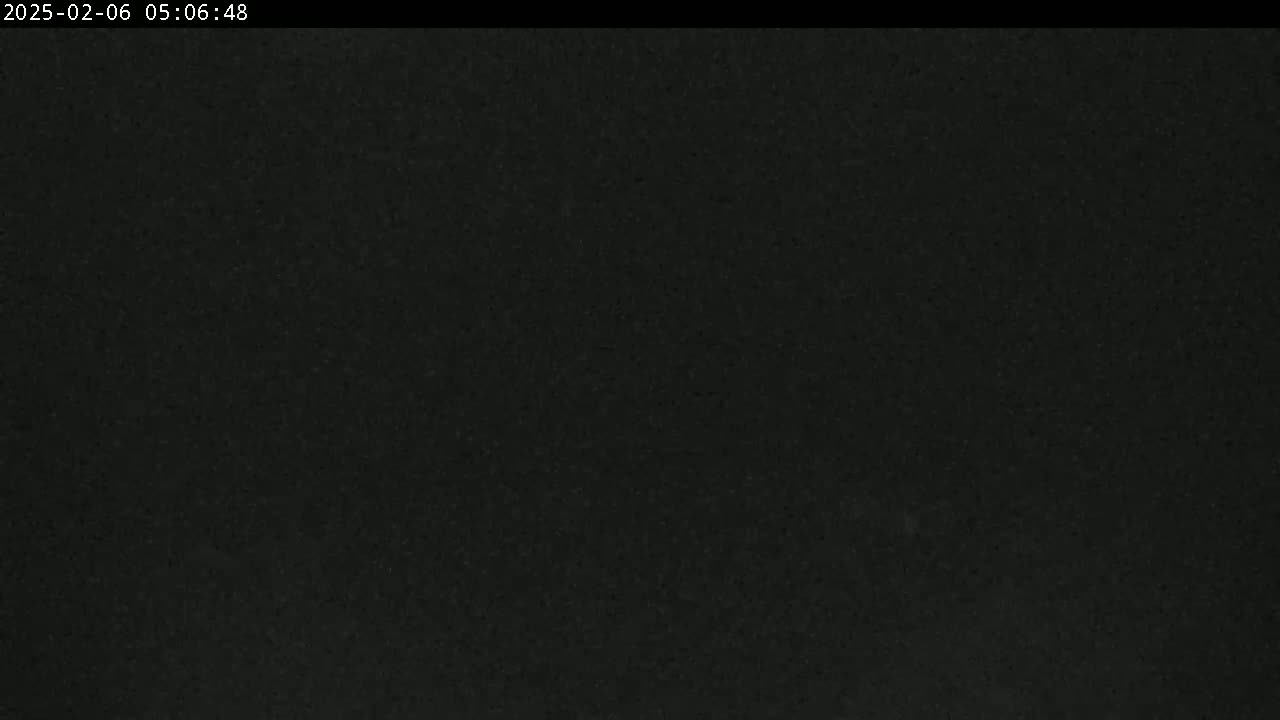 A dark, grainy image shows a mostly uniform black surface.