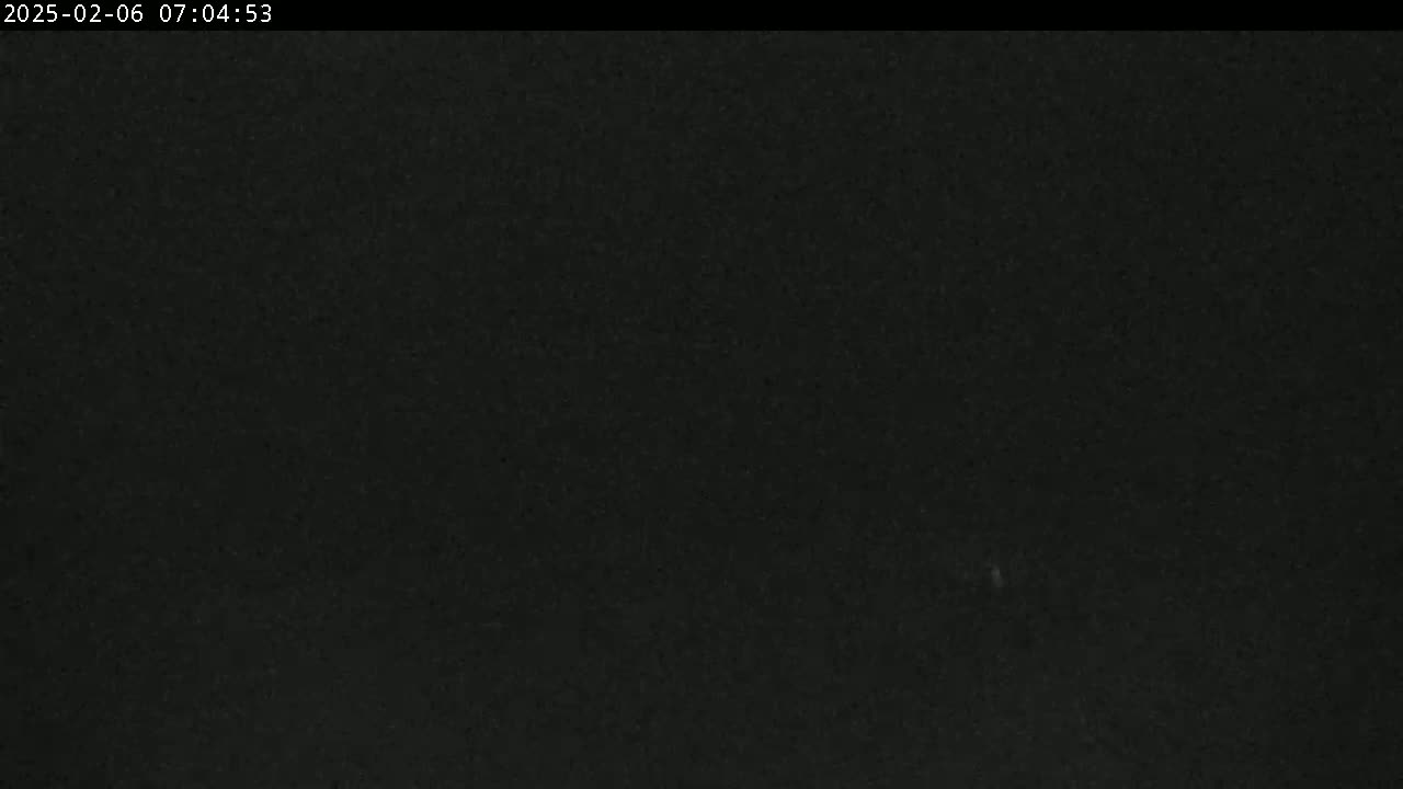 The image shows a dark, uniformly colored expanse, possibly a night sky or a dark surface.