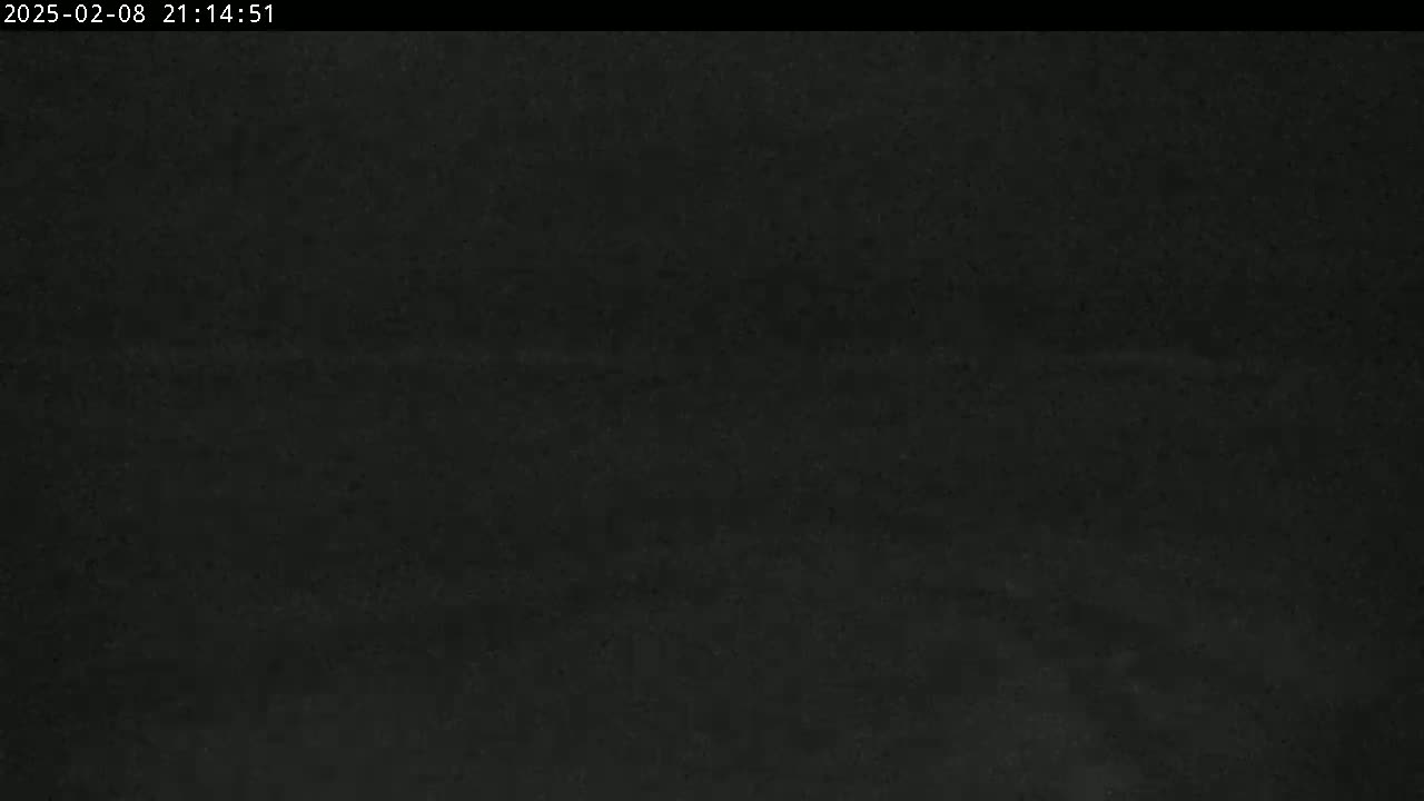 A dark, mostly featureless image shows a possibly nighttime outdoor scene with poor visibility.