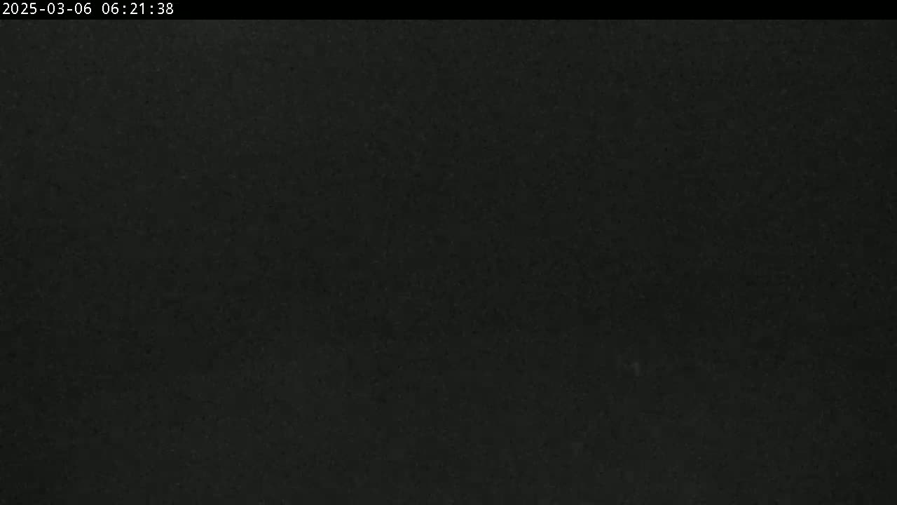 A dark, mostly featureless image suggests nighttime conditions.
