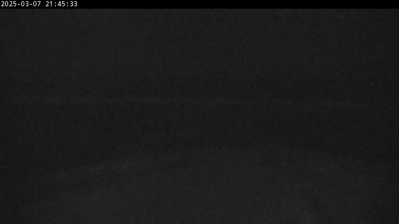 The image shows a completely dark, possibly nighttime, scene with a slightly grainy texture.